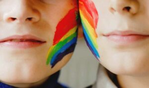 two girls with rainbow paint on their faces